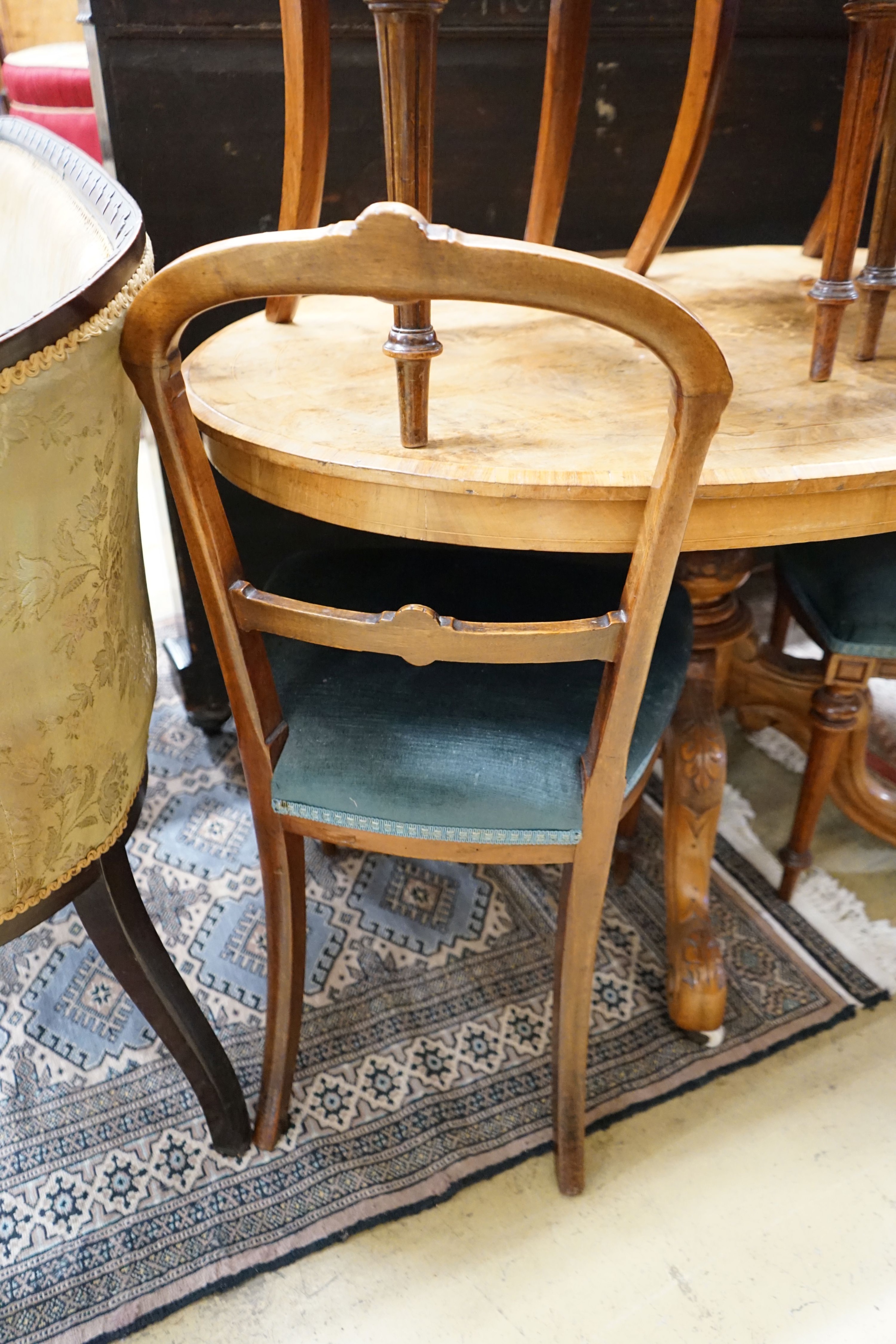 A Victorian burr walnut oval topped loo table, width 120cm, depth 85cm, height 70cm together with four Victorian walnut dining chairs (5)